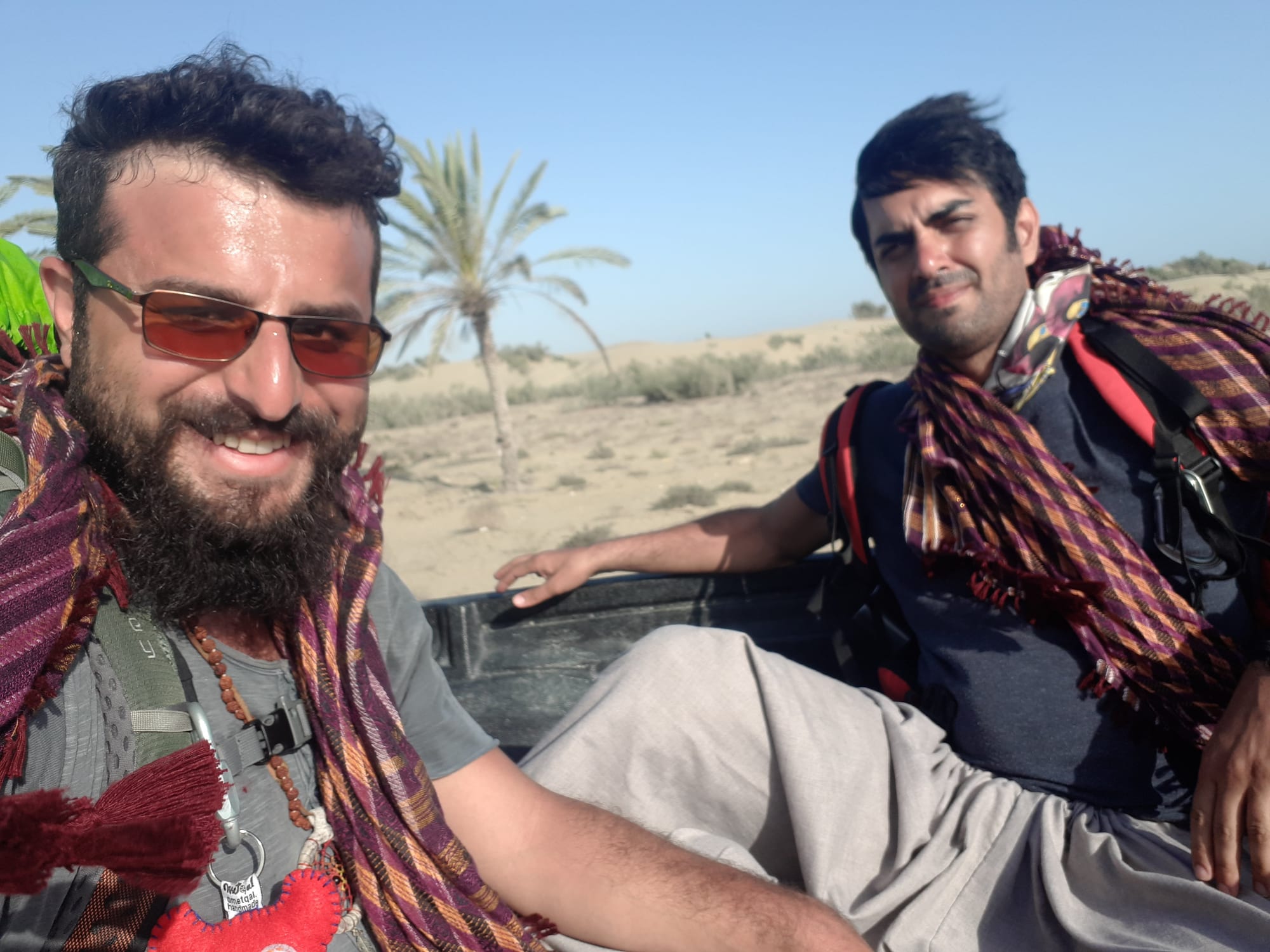 Pure joy hitchhiking in the back of a pickup truck on our way to Darak!